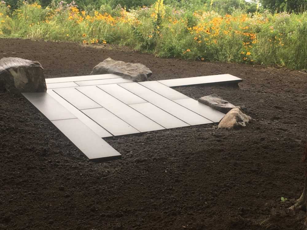 This landing and set of steps was designed to have a cross hatch style of pattern.  Boulders anchor this landscape feature and create a nice juxtapose to the linear pattern of the bluestone treads.