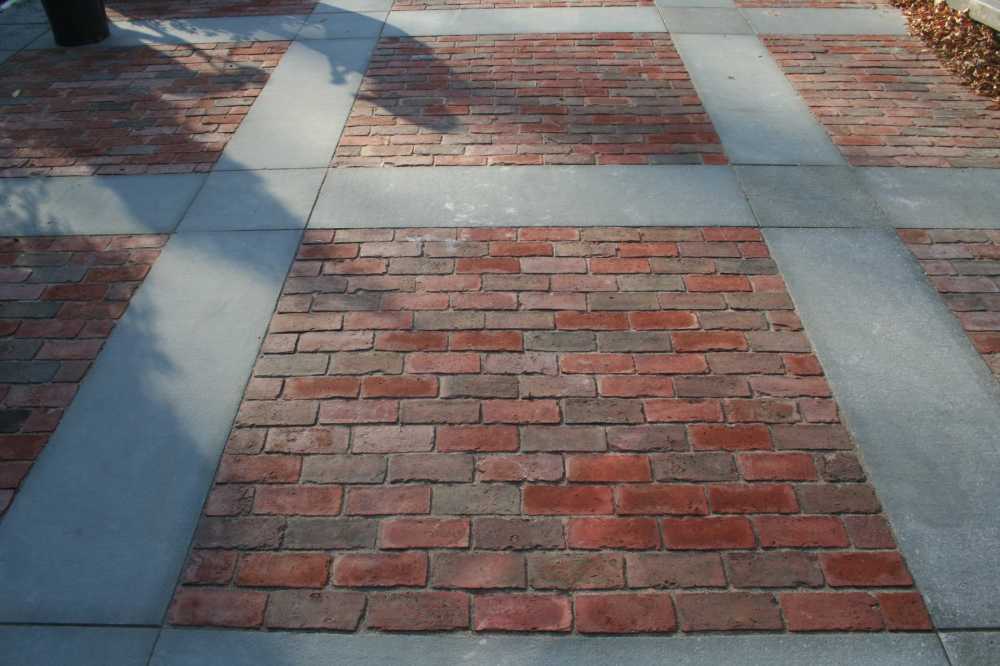 Reclaimed brick with a lattice of bluestone makes a colorful paving choice.