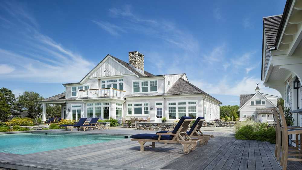 This waterfront pool project was designed and installed by Atlantic.  Dimauro Arcitects and Gardner Woodwrights created this beautiful home and pool house.  The Ipe deck is cool on bare feet and neatly conceals the pool's automatic cover.  Coastal plants 