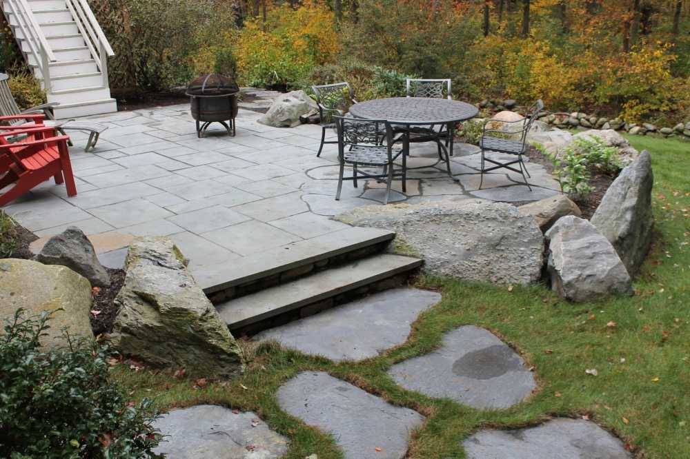 This random rectangular bluestone patio overlooks a peaceful woodland setting.